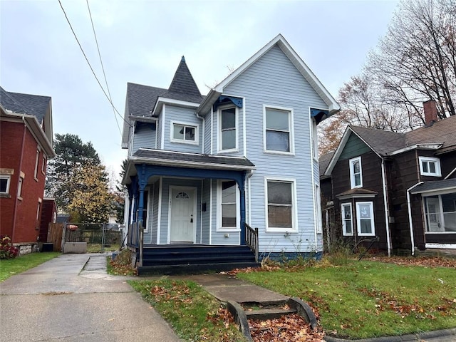 victorian home featuring a front yard