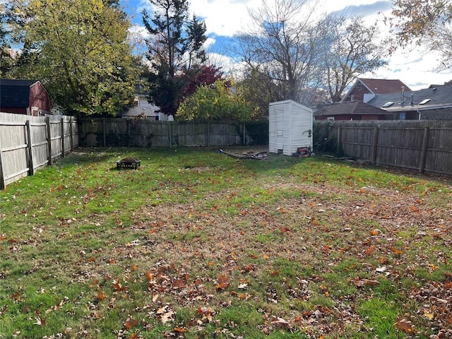 view of yard with a fire pit and a storage shed