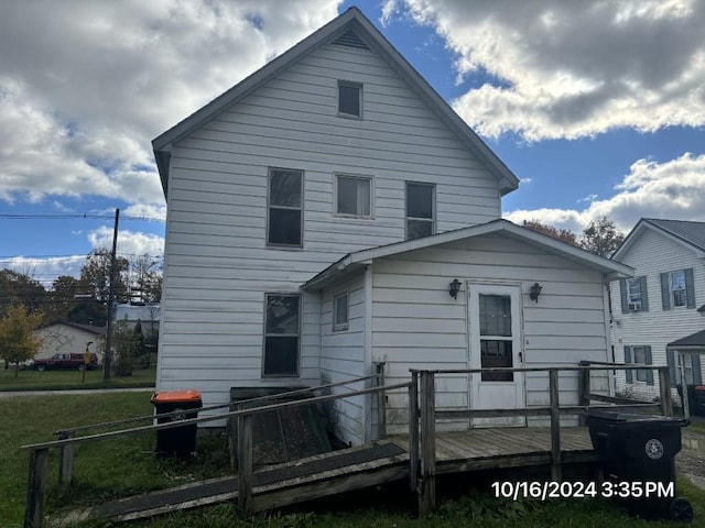 back of property featuring a deck