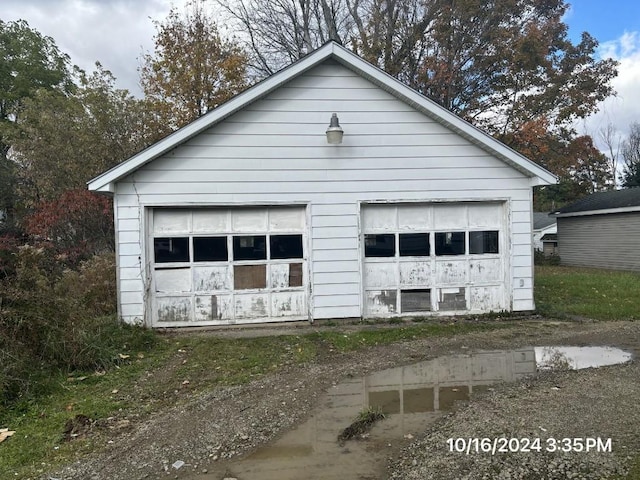 view of property exterior with a garage and an outbuilding