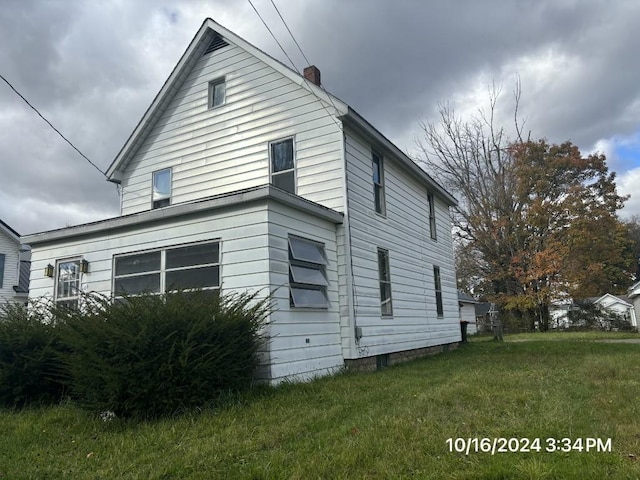 view of home's exterior featuring a lawn