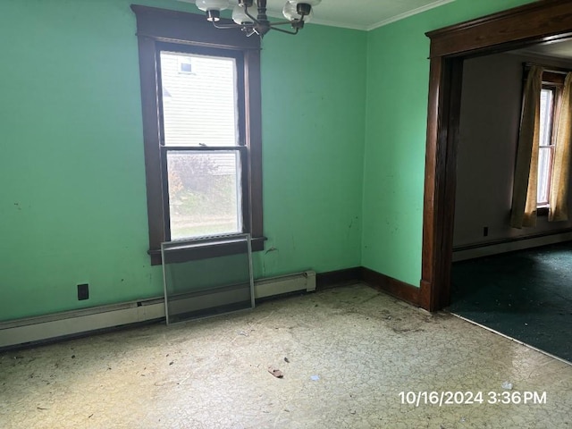 spare room with a notable chandelier, crown molding, and a baseboard radiator