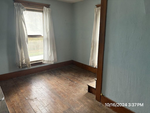 unfurnished room with hardwood / wood-style flooring and plenty of natural light