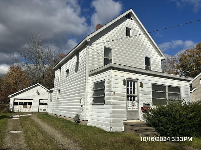 view of front of home with an outdoor structure and a garage