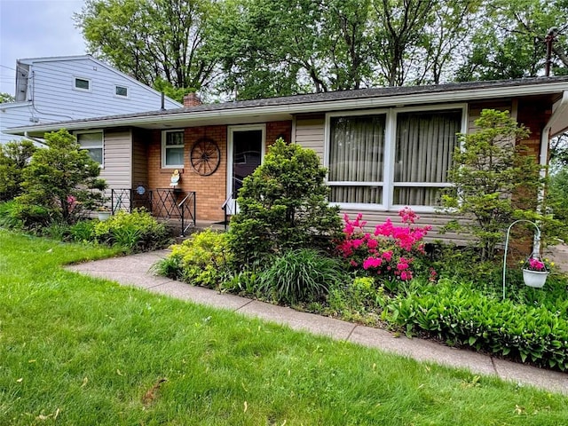 1426 W 45th St, Erie, PA 16509 - view of front of home with a chimney, brick siding, and a front lawn