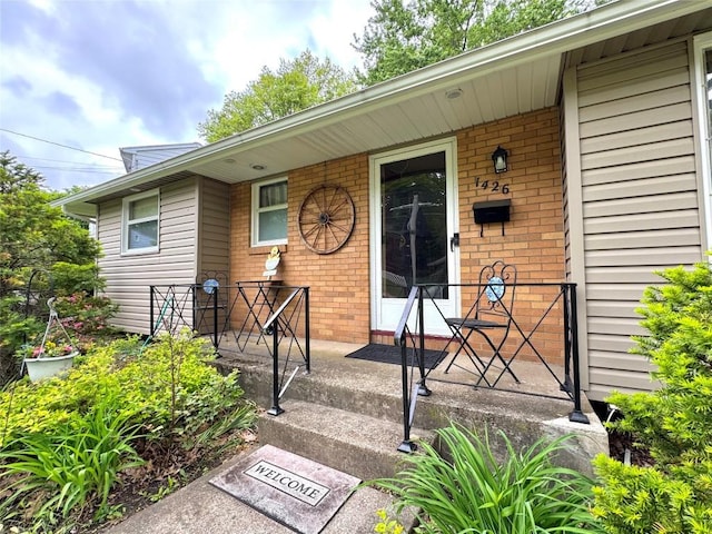 1426 W 45th St, Erie, PA 16509 - property entrance featuring covered porch and brick siding