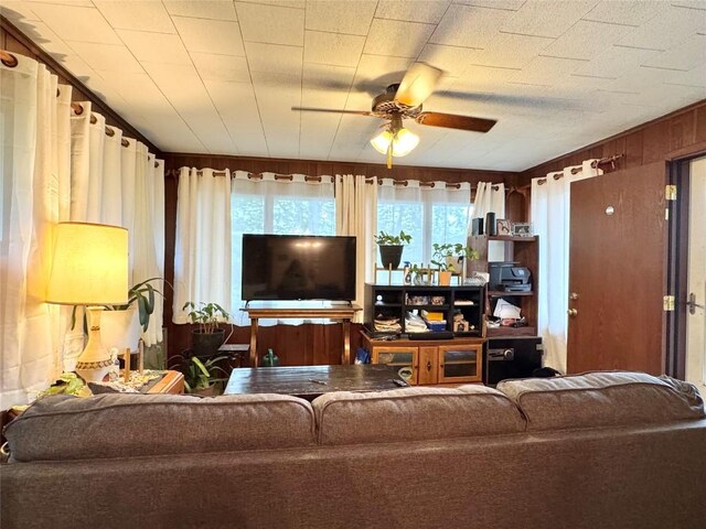 1426 W 45th St, Erie, PA 16509 - living area featuring ceiling fan and wood walls