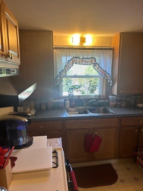 kitchen with light tile patterned floors and sink