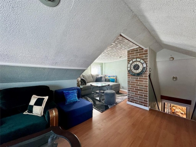 additional living space with wood-type flooring, a textured ceiling, and vaulted ceiling