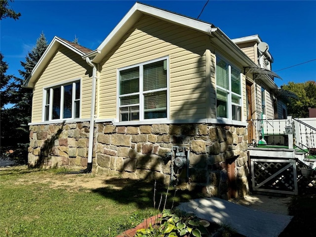 view of side of home featuring a yard