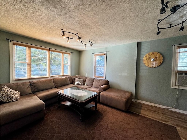 living room featuring cooling unit and a textured ceiling