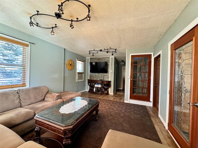 living room featuring a textured ceiling and a healthy amount of sunlight