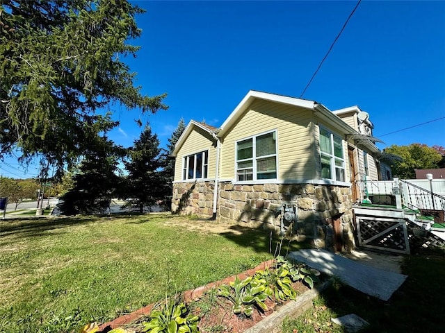 view of property exterior with a yard