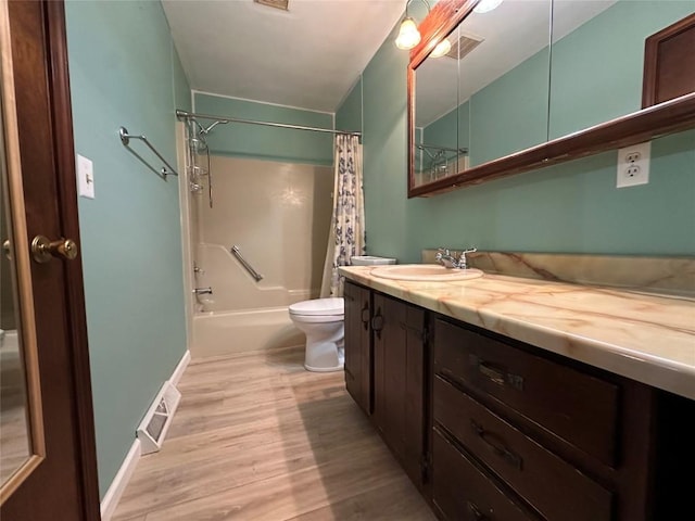 bathroom with visible vents, wood finished floors, toilet, and vanity
