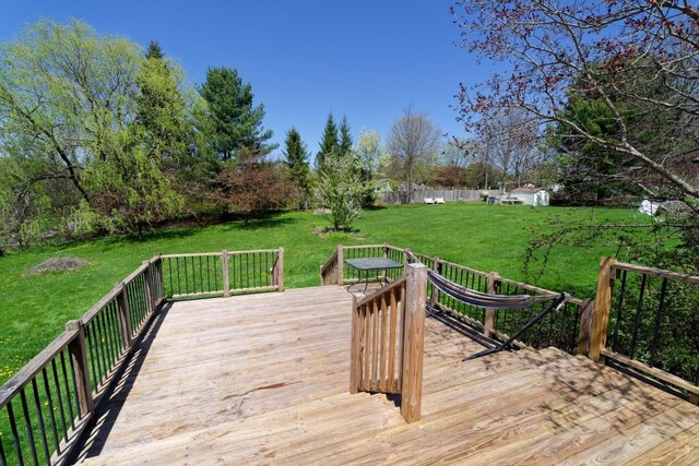 wooden terrace featuring a yard
