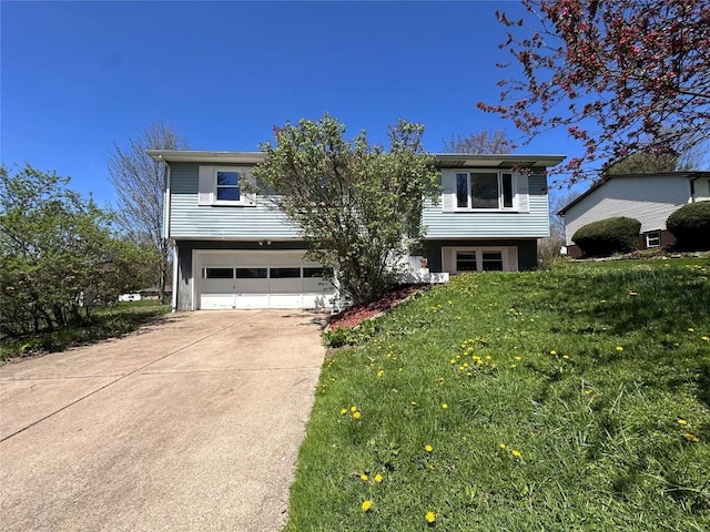 bi-level home featuring driveway, a front lawn, and a garage