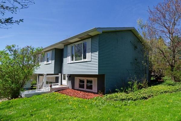 back of property featuring a yard