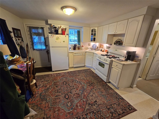 kitchen featuring white cabinets and white appliances