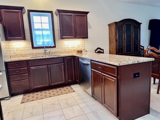 kitchen with decorative backsplash, a peninsula, marble finish floor, stainless steel appliances, and a sink