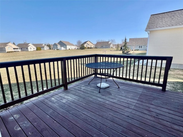 wooden deck with a residential view and a lawn