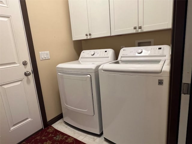 clothes washing area with cabinet space and washer and clothes dryer