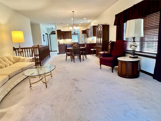 living room featuring recessed lighting, light carpet, and a notable chandelier