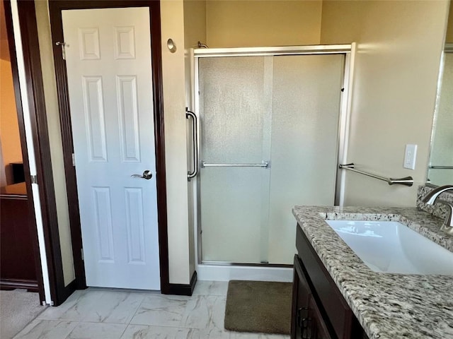 bathroom with vanity, a shower stall, baseboards, and marble finish floor