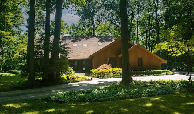 view of property exterior with a lawn