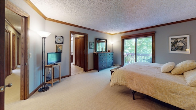 carpeted bedroom featuring access to exterior, a textured ceiling, and ornamental molding