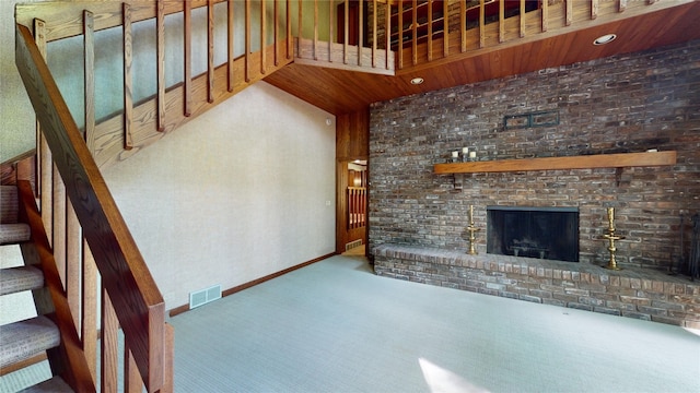 unfurnished living room with carpet, wood ceiling, and a fireplace