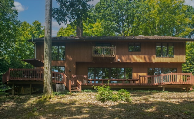 back of house featuring a wooden deck