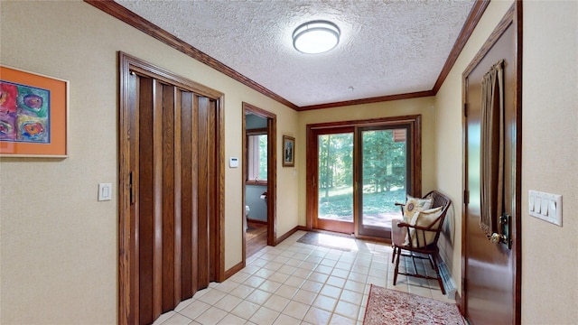 doorway to outside featuring light tile patterned floors, a textured ceiling, and ornamental molding