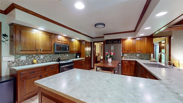 kitchen with backsplash, kitchen peninsula, sink, and appliances with stainless steel finishes