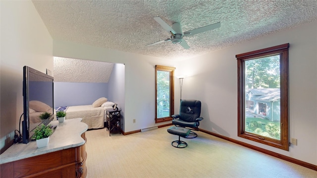 carpeted bedroom with a textured ceiling and ceiling fan