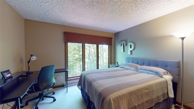 bedroom with carpet floors and a textured ceiling