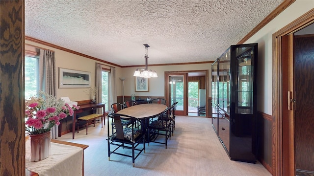 dining room with light carpet, crown molding, a healthy amount of sunlight, and a notable chandelier