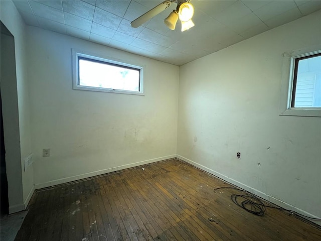 spare room with ceiling fan and dark wood-type flooring