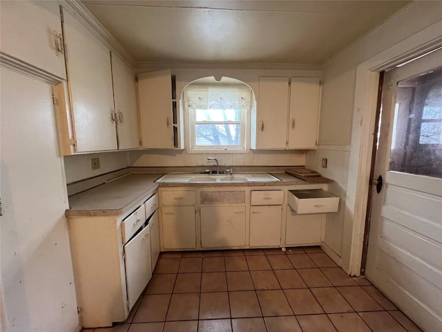 kitchen with white cabinetry, sink, and tile patterned flooring