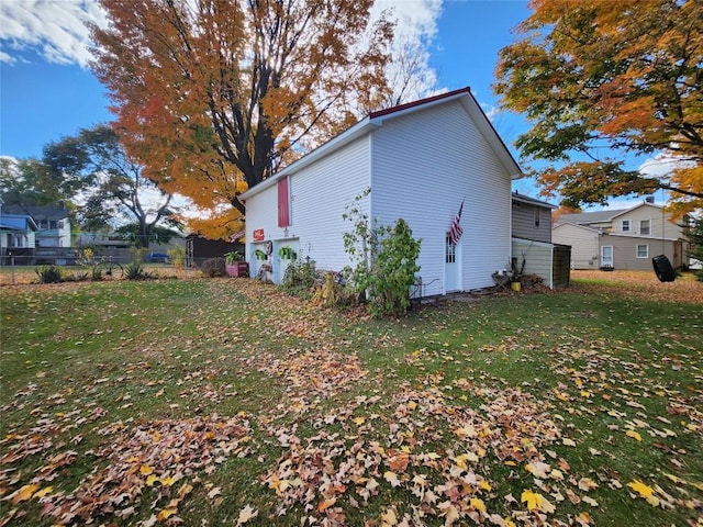 view of property exterior with a lawn