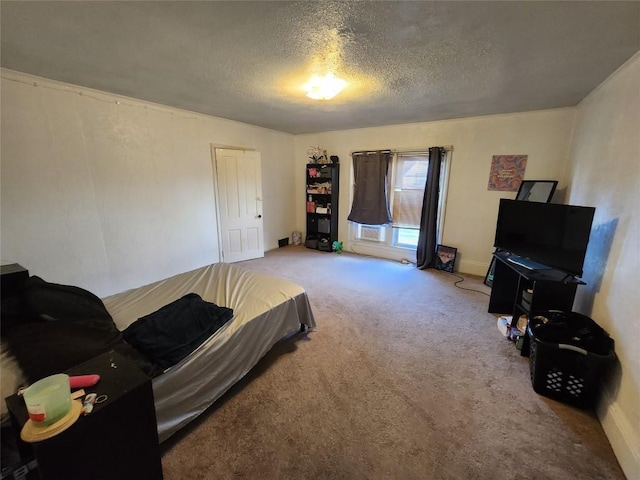 bedroom with carpet flooring and a textured ceiling