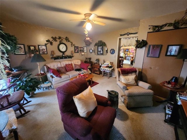 carpeted living room with ceiling fan