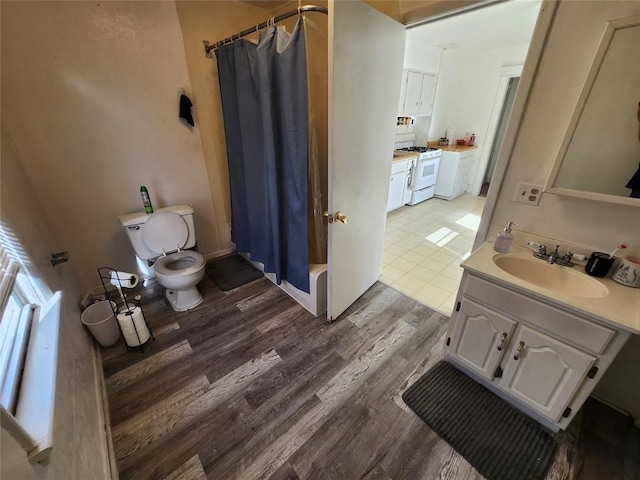 full bathroom featuring vanity, hardwood / wood-style flooring, toilet, and shower / bath combo with shower curtain