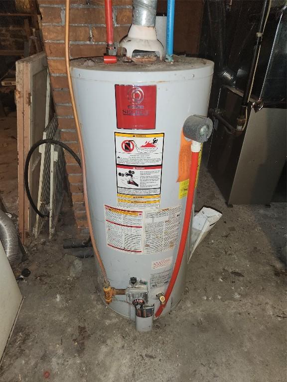 utility room with heating unit and gas water heater