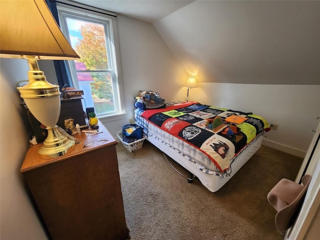 carpeted bedroom with lofted ceiling