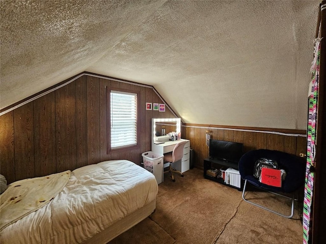 bedroom with vaulted ceiling, wooden walls, a textured ceiling, and carpet