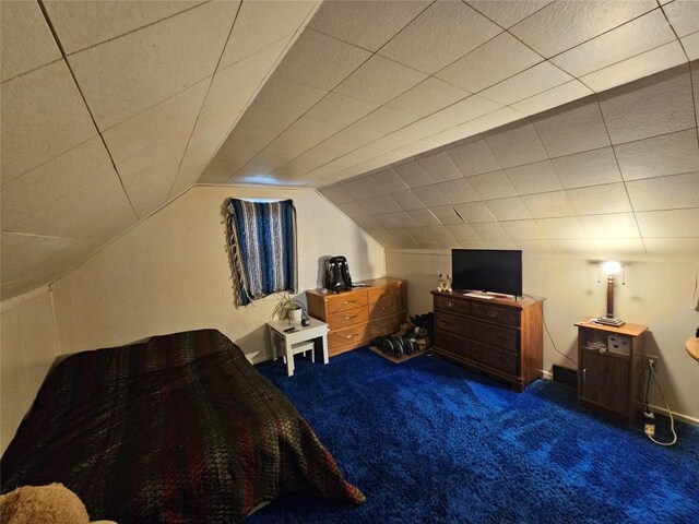 bedroom featuring lofted ceiling and carpet floors