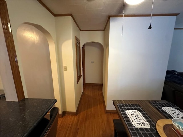 hall with light hardwood / wood-style flooring and ornamental molding