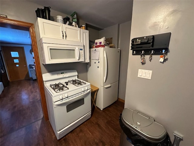 kitchen featuring white cabinets, dark hardwood / wood-style floors, and white appliances