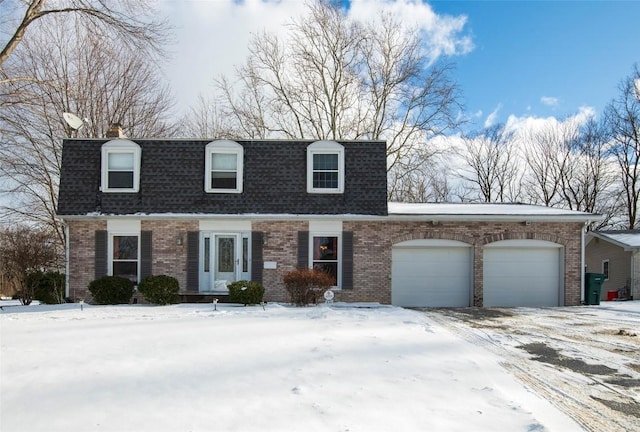 cape cod house featuring a garage