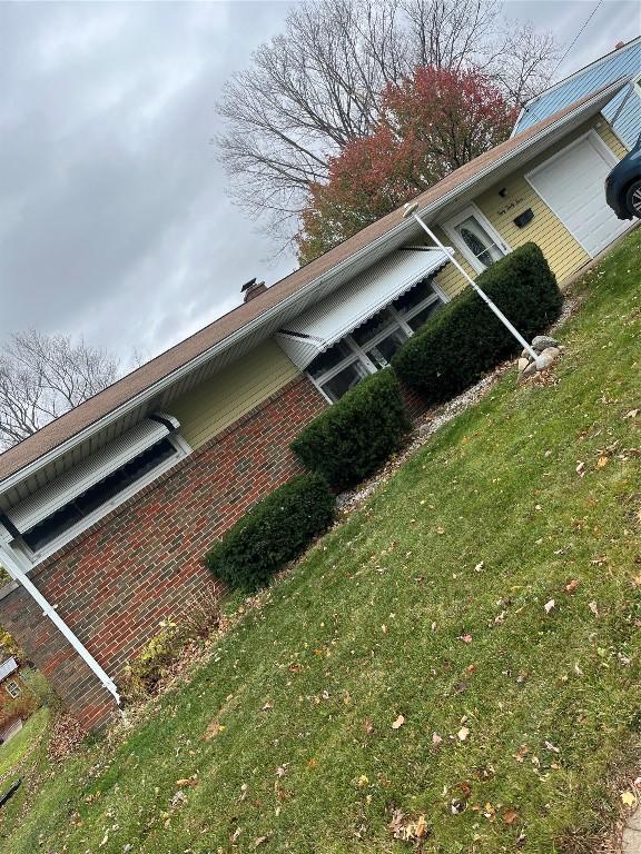 view of side of home featuring a lawn